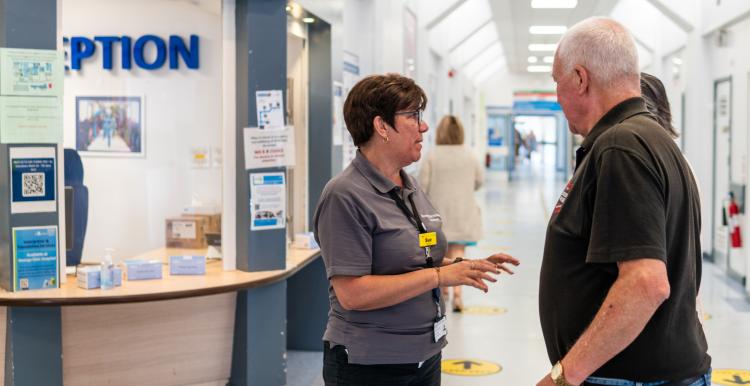 Woman speaking to man in hospital