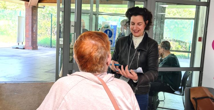 Healthwatch Greenwich representative at the dementia action event in Greenwich speaking with a carer.