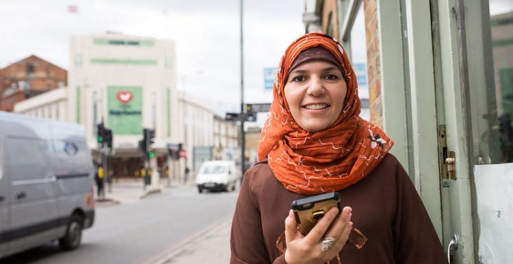 Smiling woman wearing hijab at a local street