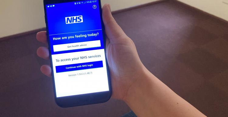 Someone using the NHS App on a smartphone