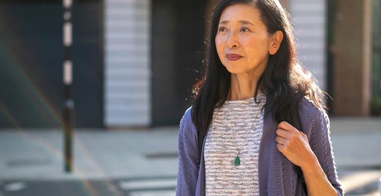 Woman walking outside on a bright day