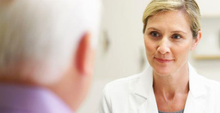 Female doctor talking to an older male patient