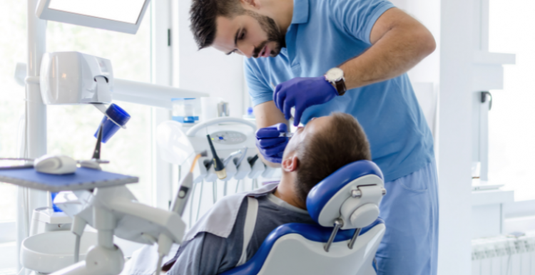 Dentist treats a patient in bright room