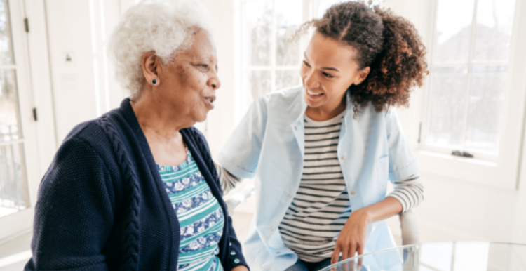 Image of older woman being cared for at home in bright room