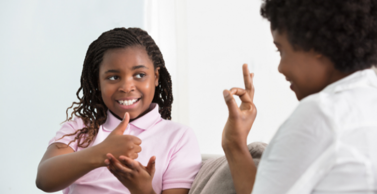 child using sign language with adult