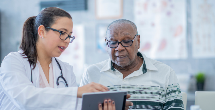 Healthcare professional helps older man