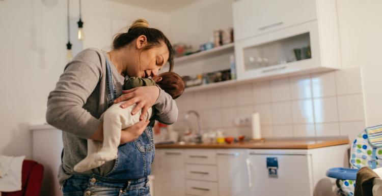 Woman holding baby in her kitchen.jpg