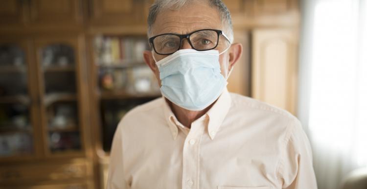 an elderlry man wearing a mask