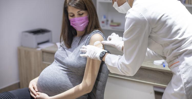 Pregnant woman being vaccinated