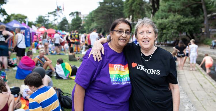  two women at pride with their arms around each other 