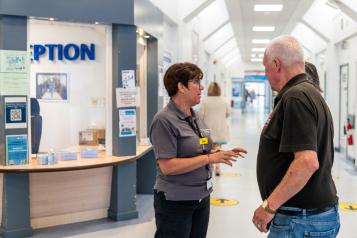 Woman speaking to man in hospital