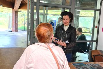 Healthwatch Greenwich representative at the dementia action event in Greenwich speaking with a carer.