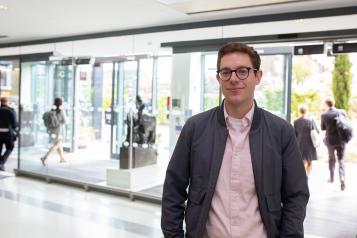 A man standing in a hospital reception area