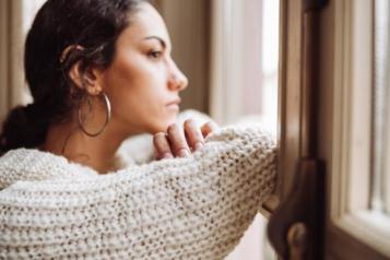 Woman looks out of a window