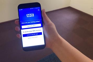 Someone using the NHS App on a smartphone