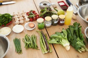 A colourful array of healthy vegetables on a wooden counter