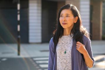 Woman walking outside on a bright day