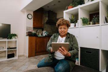 Woman on an ipad in her own home