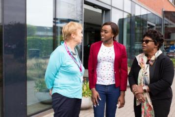 Three women talking outside hospital