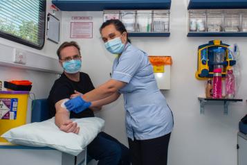 man getting a blood test at a mobile clinic