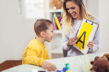 Image of child being supported by a health care professional