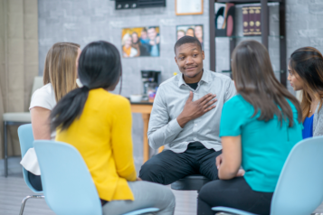 man addresses group of people