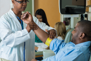 man giving blood in hospital