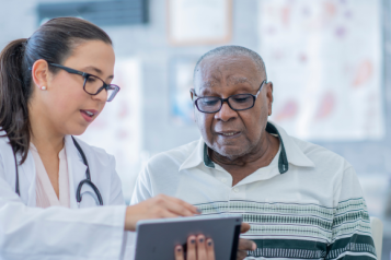 Healthcare professional helps older man