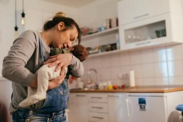 Woman holding baby in her kitchen.jpg