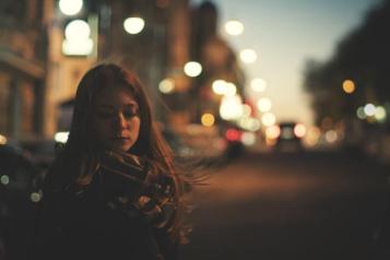 Woman standing outside at night