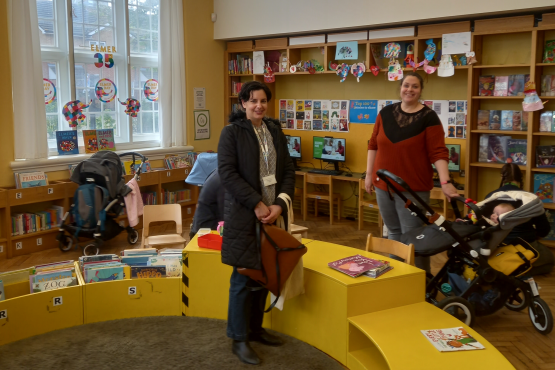 Healthwatch Greenwich representative engaging with a parent at Plumstead Library