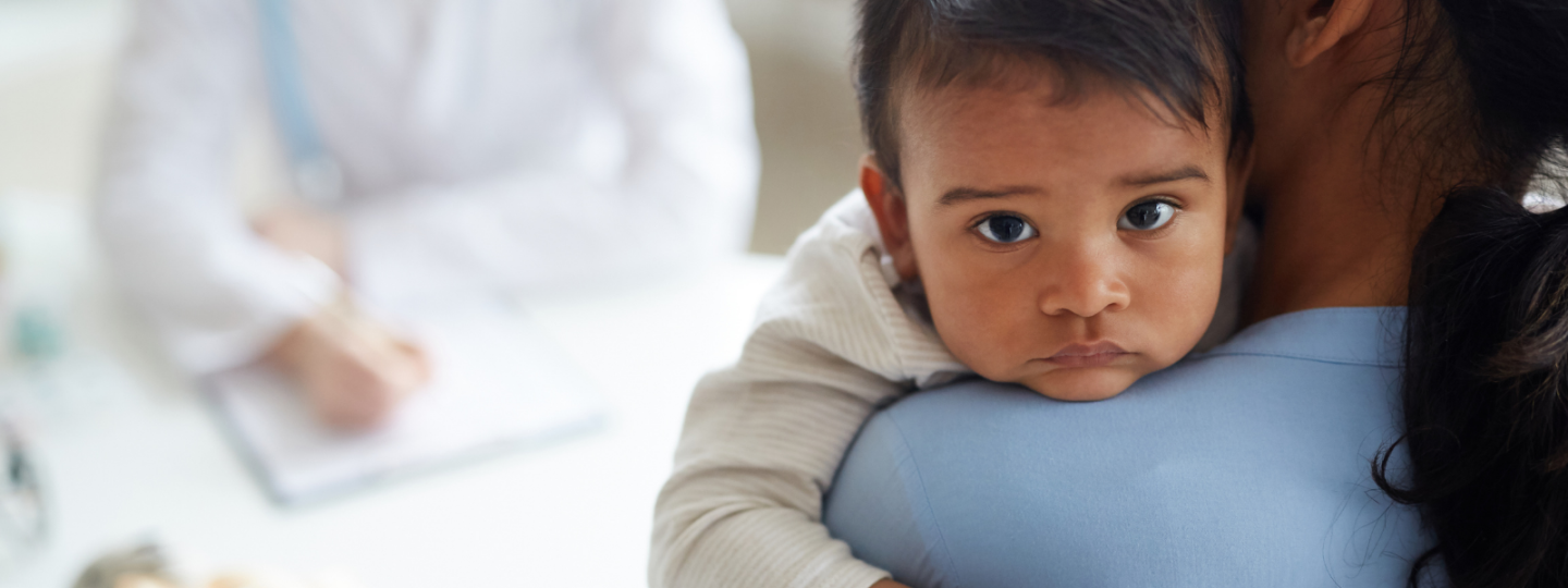 newborn baby looks into camera