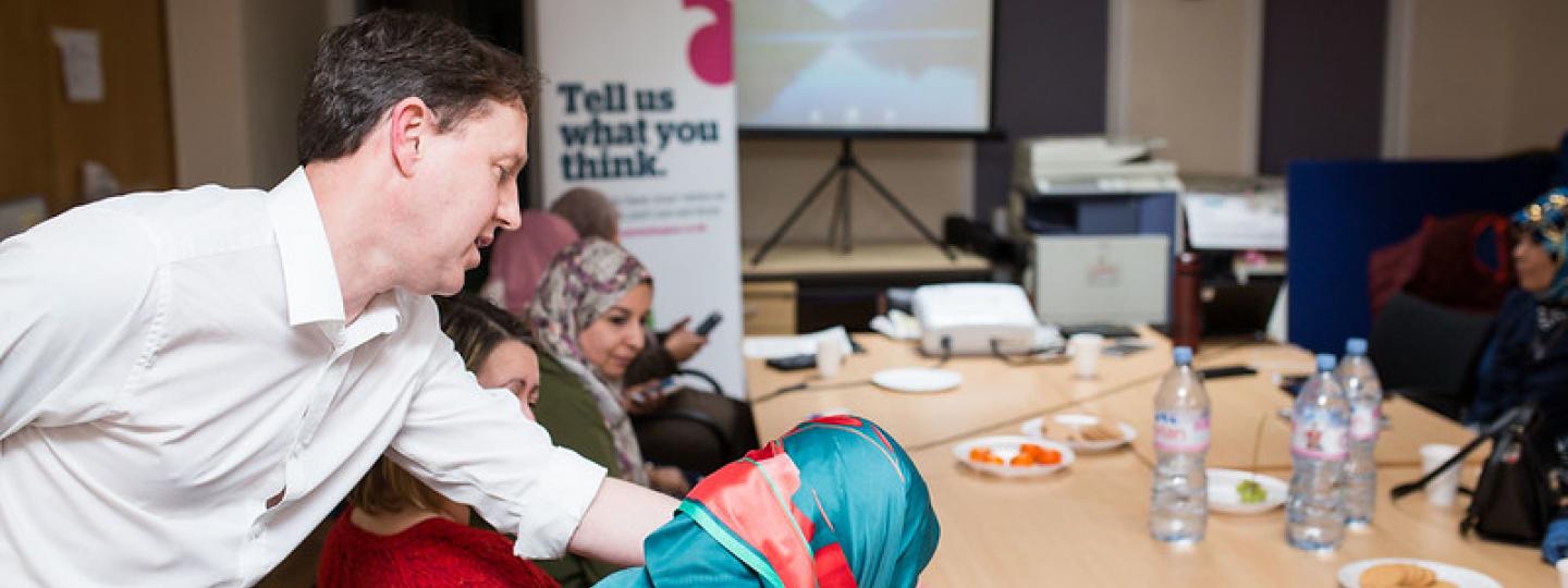 Healthwatch people talk at a meeting