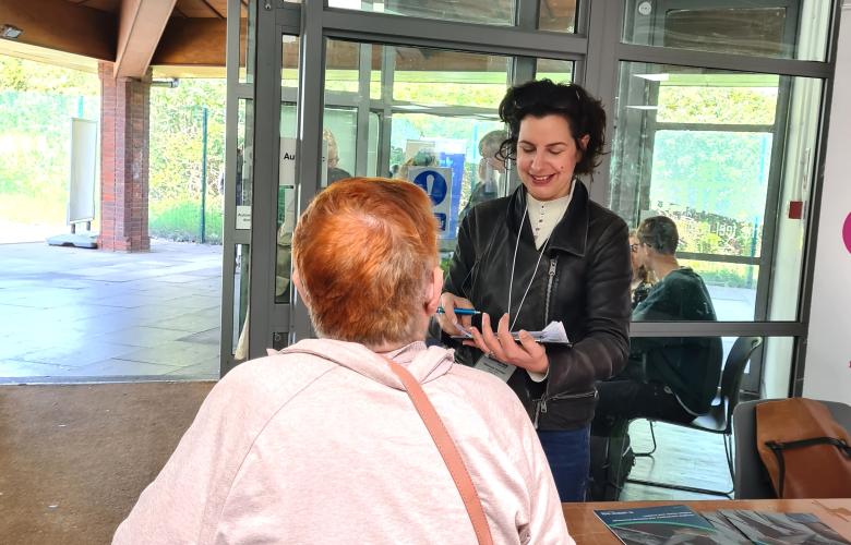 Healthwatch Greenwich representative at the dementia action event in Greenwich speaking with a carer.