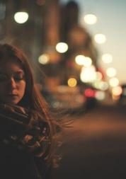 Woman standing outside at night